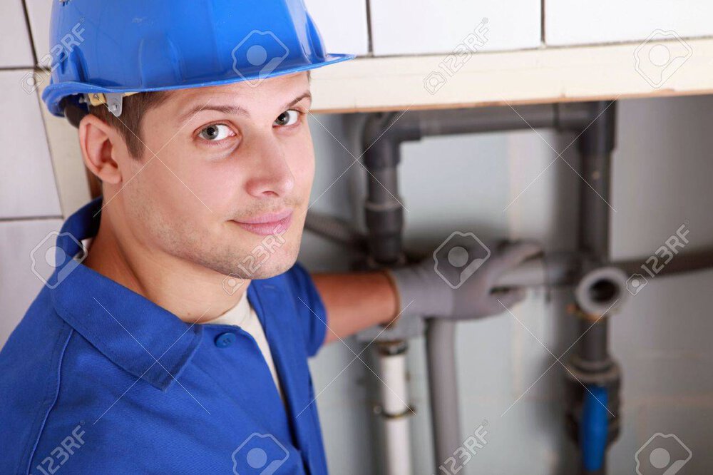 12499637-Young-male-plumber-installing-p